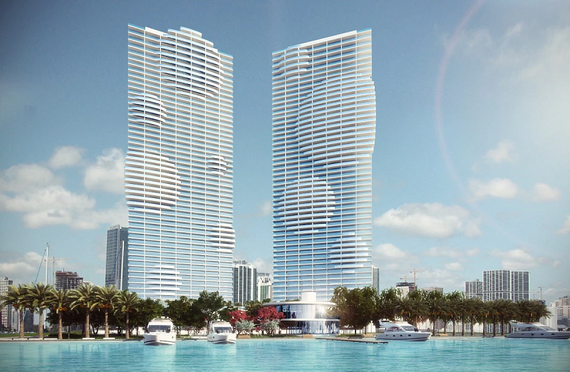 two building render of a hotel named paraiso bay right on the water with people in boats